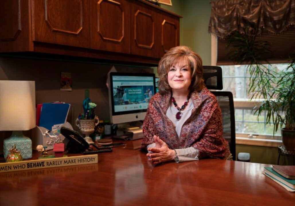 confident female business broker at desk